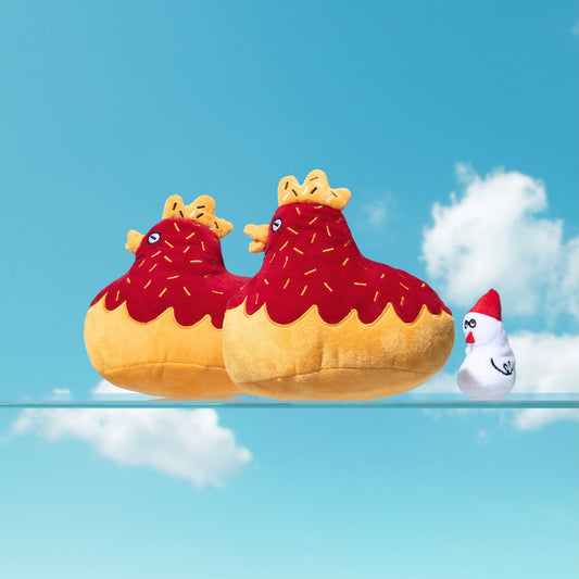Two inflatable chicken-shaped pool floats on a clear blue sky background with a small chicken figure.